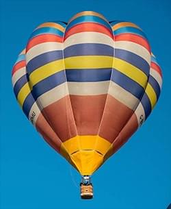 A colorful hot air balloon against a clear sky
