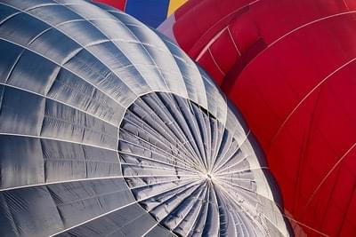 A close-up of two hot air balloons being inflated.